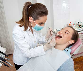 Dentist checking patient's mouth